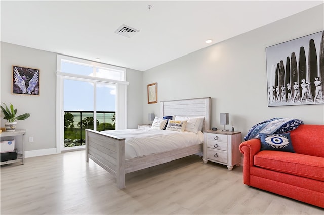 bedroom with light wood-type flooring and access to exterior