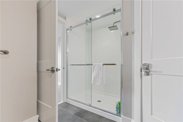 bathroom with tile patterned floors and a shower with shower door