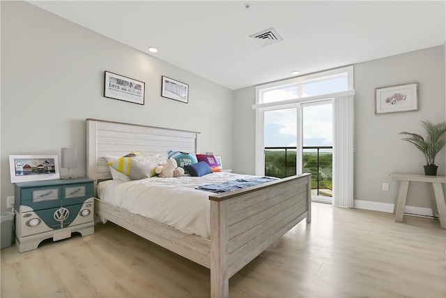 bedroom with light hardwood / wood-style floors and access to outside