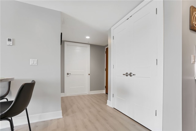 home office with light hardwood / wood-style flooring