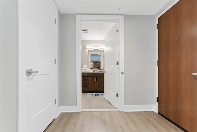 corridor featuring light hardwood / wood-style floors