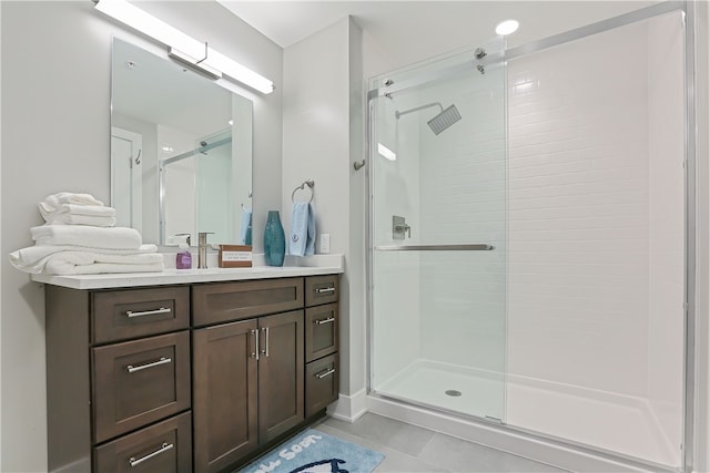 bathroom featuring vanity, tile patterned floors, and a shower with shower door