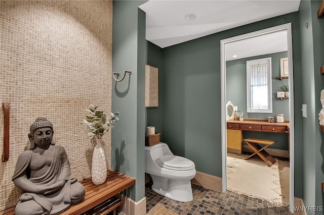 bathroom with tile walls, toilet, and tile patterned floors