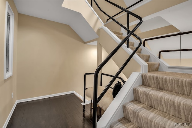 stairs featuring wood-type flooring