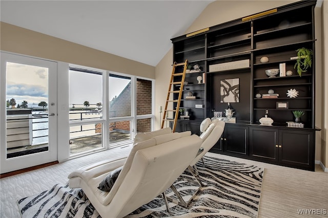 office with french doors, light colored carpet, and vaulted ceiling