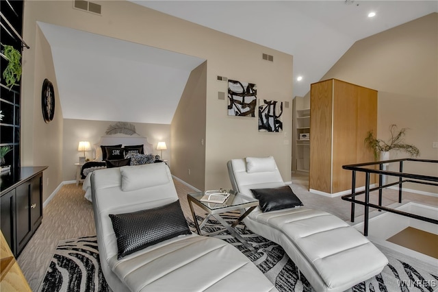 bedroom with vaulted ceiling and light carpet