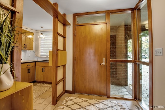 foyer entrance featuring a healthy amount of sunlight and light tile patterned floors