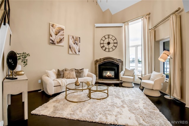 living room with high vaulted ceiling and dark hardwood / wood-style floors