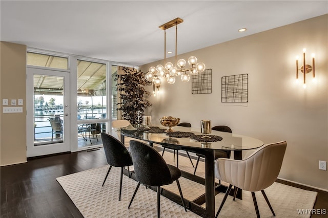 dining area with dark wood-type flooring and a wall of windows