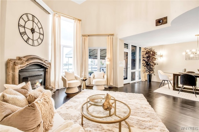 living room featuring a notable chandelier and dark hardwood / wood-style flooring