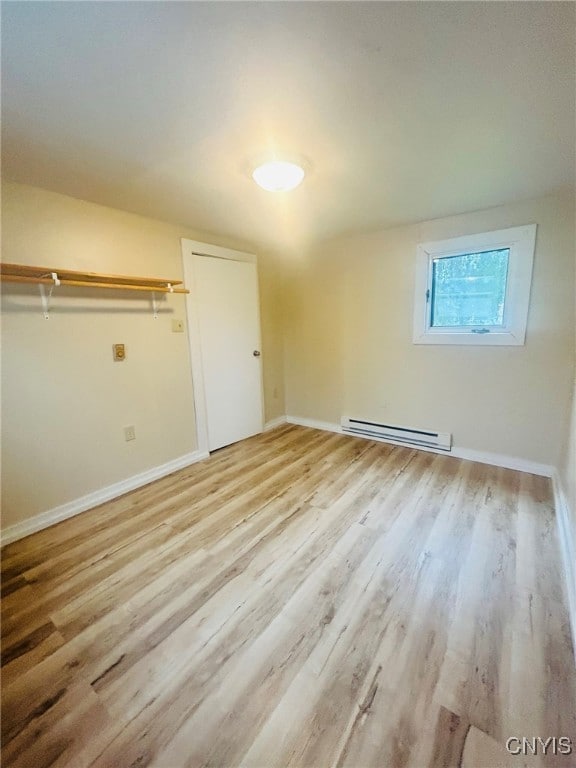 interior space featuring light hardwood / wood-style floors and a baseboard heating unit