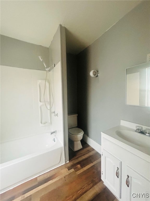 full bathroom with vanity, hardwood / wood-style floors, shower / bathing tub combination, and toilet