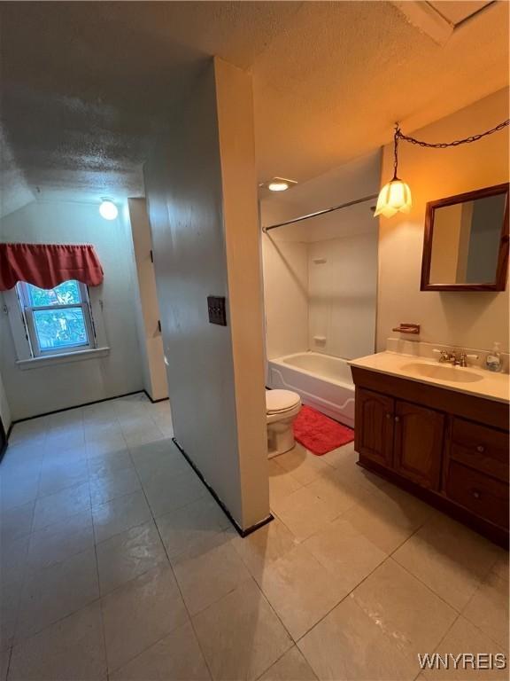 full bathroom featuring toilet, shower / tub combination, vanity, and a textured ceiling