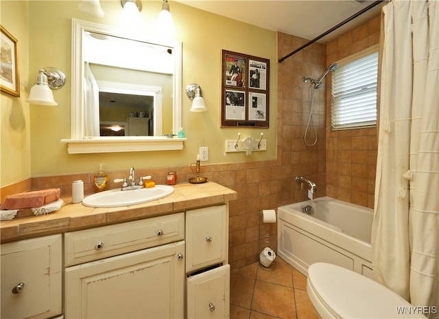 full bathroom featuring shower / tub combo, vanity, tile walls, tile patterned flooring, and toilet