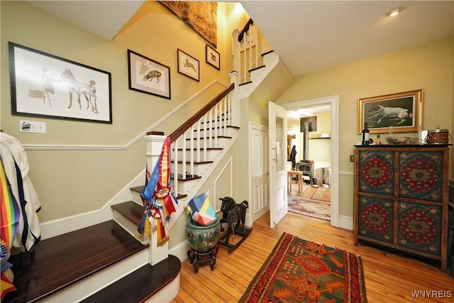 staircase with hardwood / wood-style floors