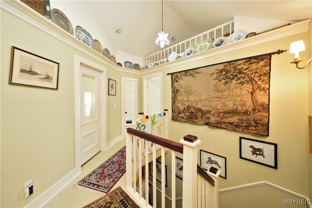 corridor with tile patterned flooring and high vaulted ceiling