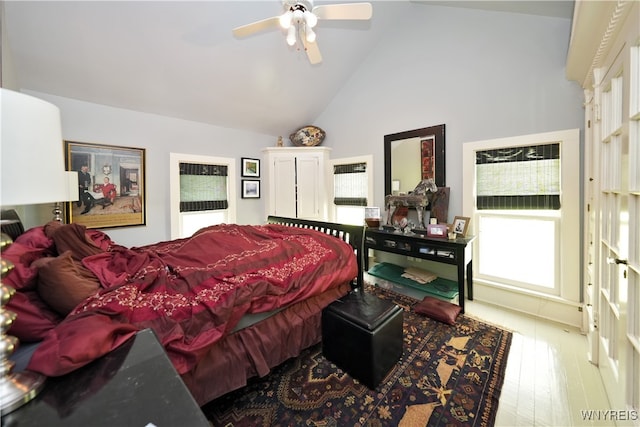 bedroom featuring ceiling fan, light wood-type flooring, and high vaulted ceiling