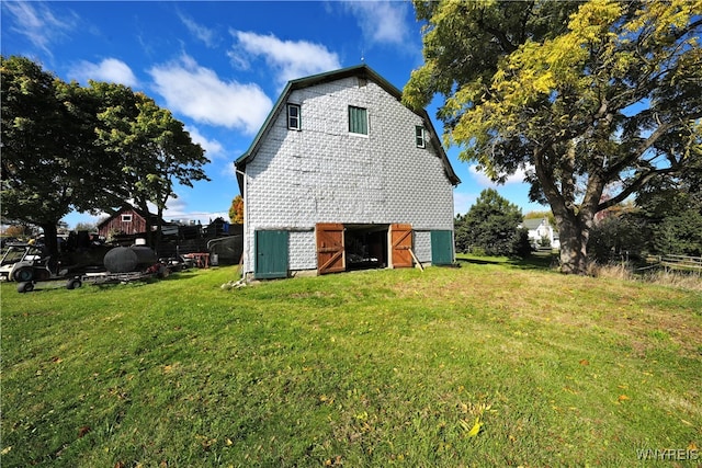 view of side of home with a lawn