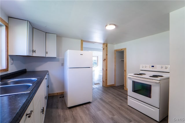 kitchen featuring sink, white cabinets, light hardwood / wood-style flooring, and white appliances