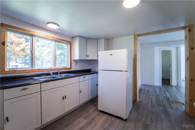 kitchen featuring white cabinetry, white fridge, sink, and dark wood-type flooring