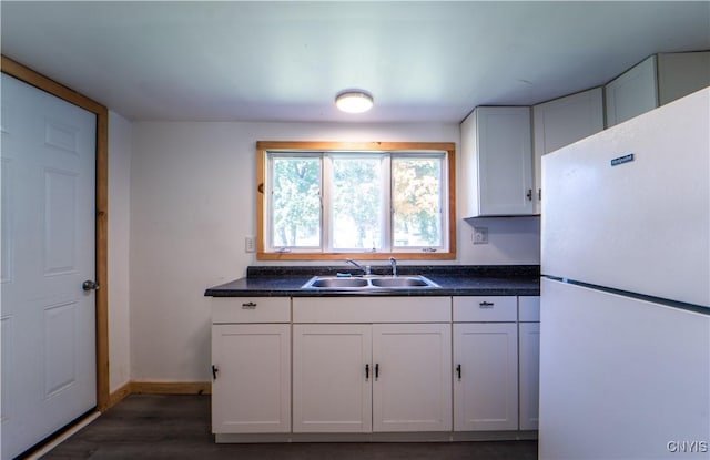 42 3rd St, German Flatts, NY 13357 - kitchen with freestanding refrigerator, a sink, dark countertops, and dark wood-style floors