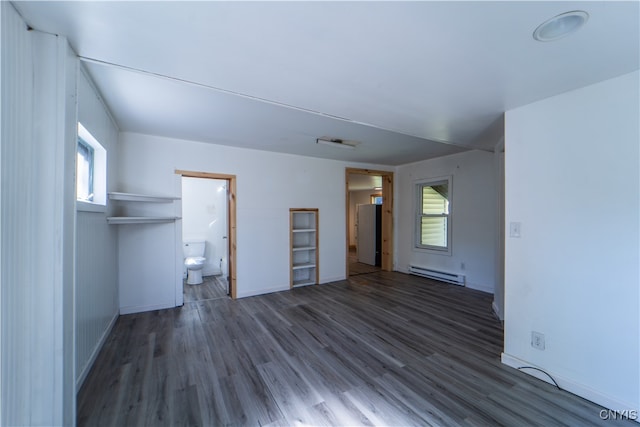 interior space featuring dark hardwood / wood-style flooring, baseboard heating, and a wealth of natural light