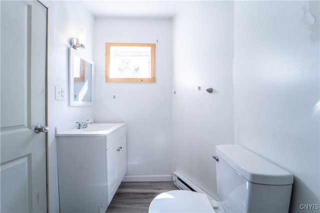 bathroom with vanity, toilet, and hardwood / wood-style floors