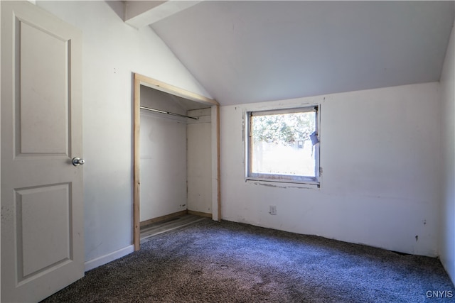 unfurnished bedroom with lofted ceiling, a closet, and carpet