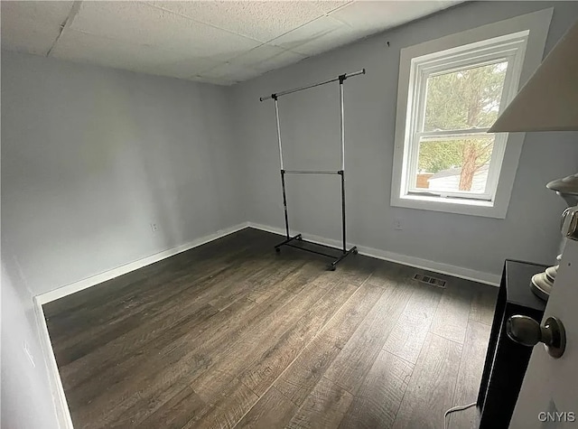 empty room with dark hardwood / wood-style flooring