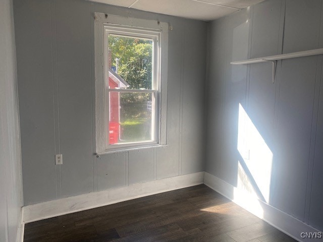 spare room with dark hardwood / wood-style floors