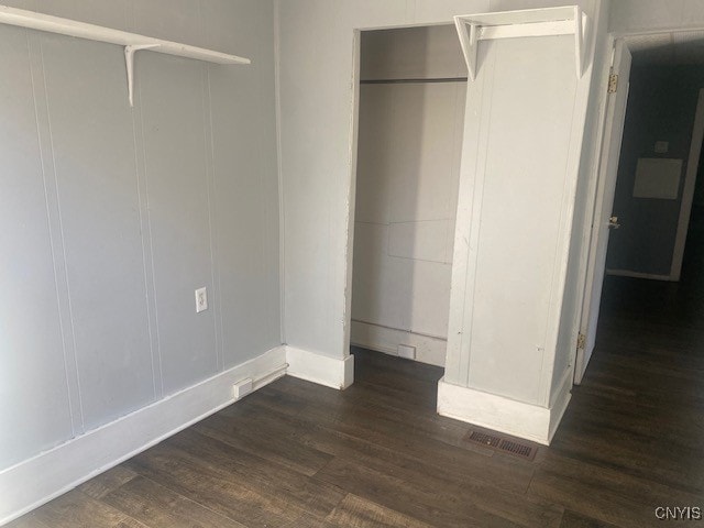 unfurnished bedroom with dark hardwood / wood-style floors