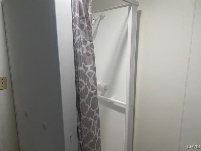 bathroom with a shower with shower curtain