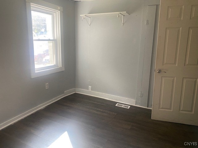 unfurnished room featuring dark wood-type flooring