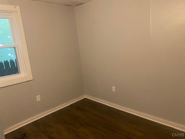 empty room with dark hardwood / wood-style floors