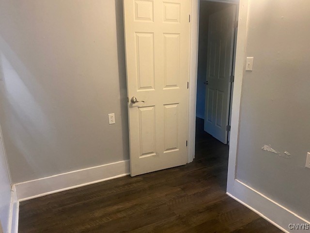 corridor with dark hardwood / wood-style floors