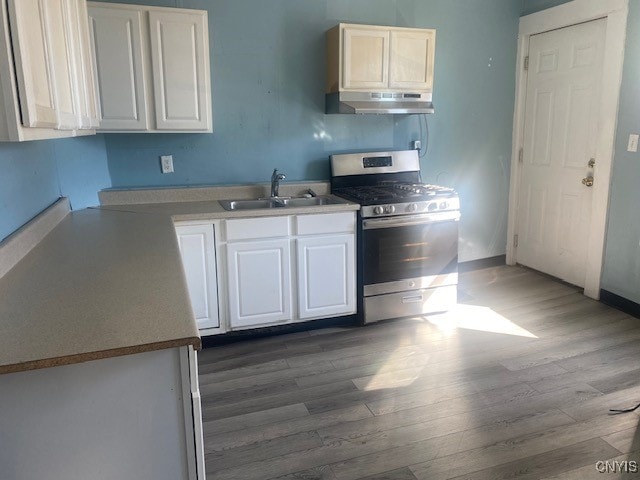 kitchen featuring white cabinetry, stainless steel range with gas cooktop, sink, and dark hardwood / wood-style flooring