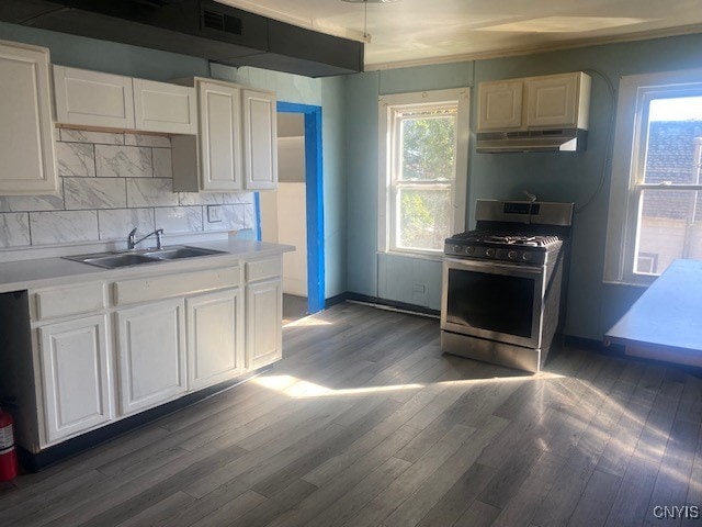 kitchen featuring a wealth of natural light, white cabinetry, and gas stove