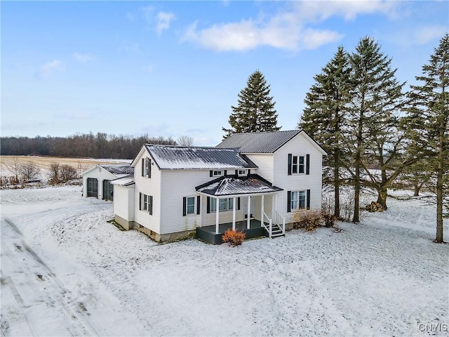 view of snow covered back of property