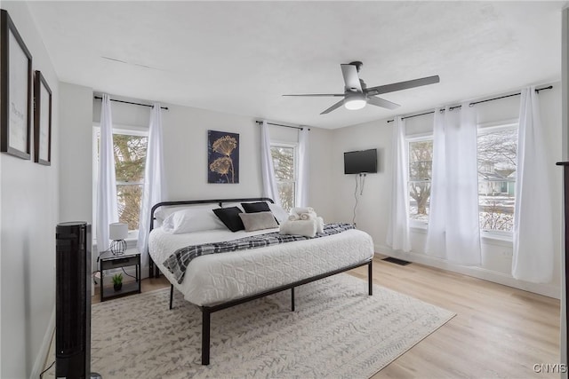 bedroom with ceiling fan and light hardwood / wood-style flooring