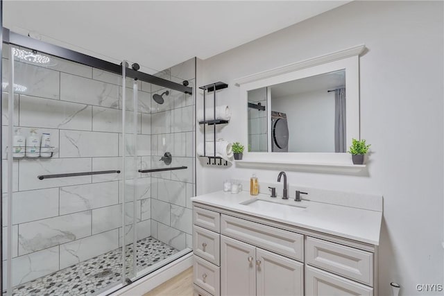 bathroom featuring vanity, an enclosed shower, and wood-type flooring