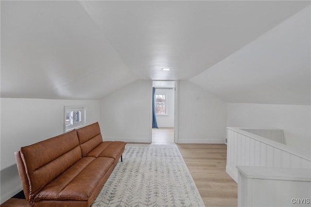 interior space with light hardwood / wood-style flooring and vaulted ceiling