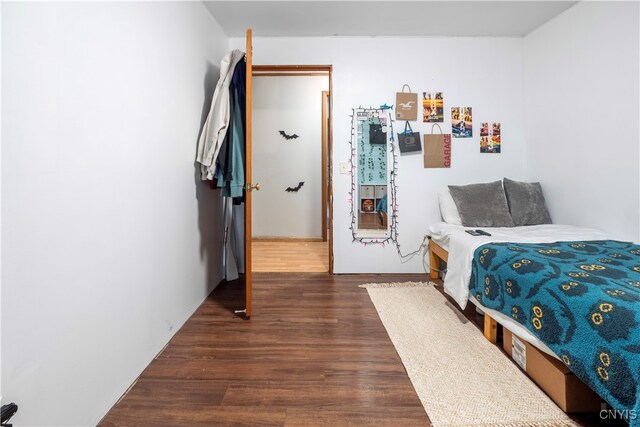 bedroom with dark hardwood / wood-style floors