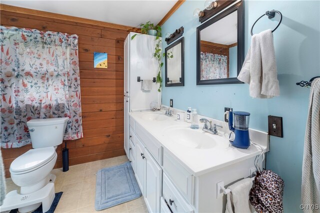 bathroom with vanity, toilet, wood walls, and tile patterned floors