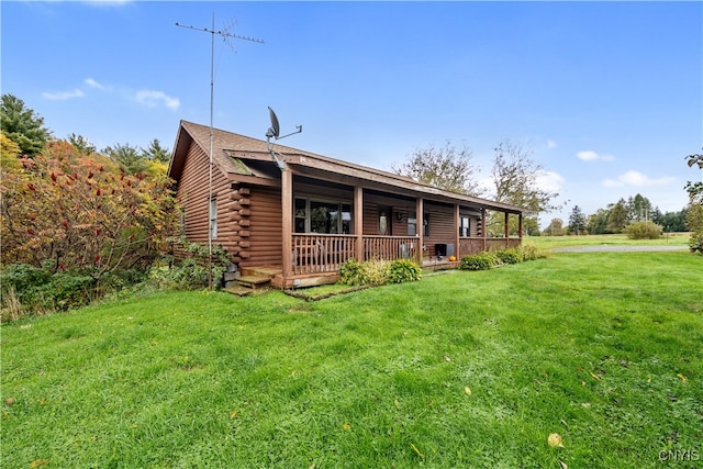 rear view of house featuring a lawn