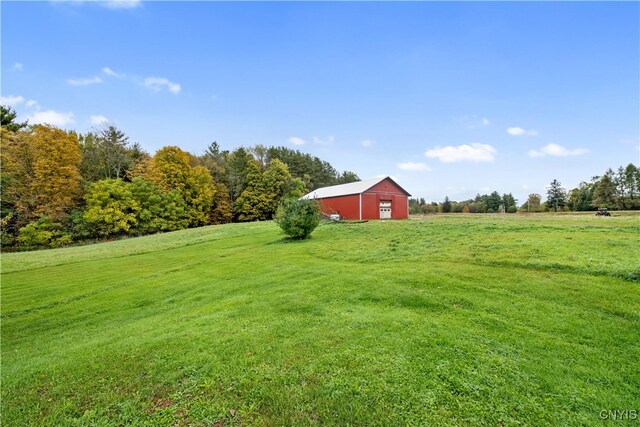 view of yard with a rural view and an outdoor structure