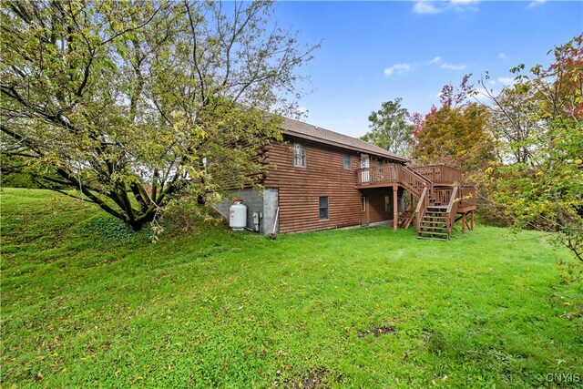 back of property featuring a yard and a deck