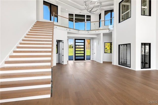 foyer with hardwood / wood-style floors and a high ceiling