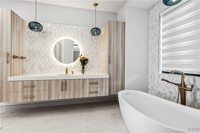 bathroom featuring vanity, decorative backsplash, a bathtub, and tile patterned flooring