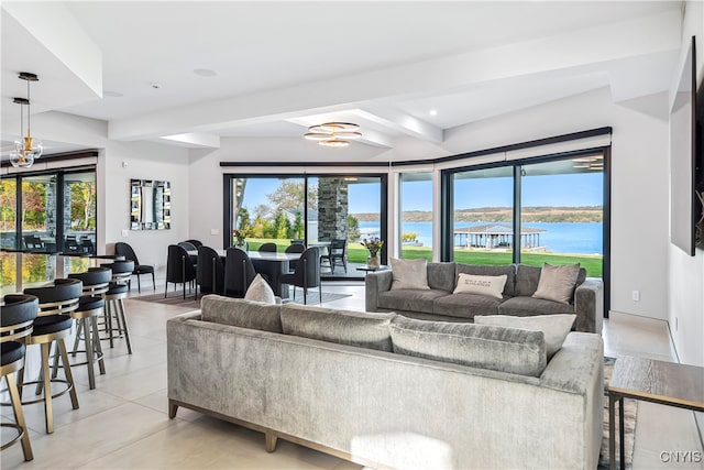 living room featuring a wealth of natural light, beamed ceiling, and a water view