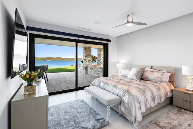 bedroom with access to exterior, light tile patterned floors, and ceiling fan